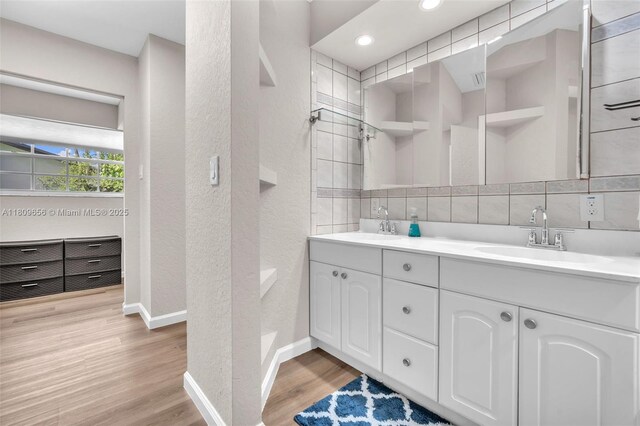 4271 SW 67th Ter, Davie, FL 33314 - full bath with double vanity, a textured wall, wood finished floors, baseboards, and recessed lighting
