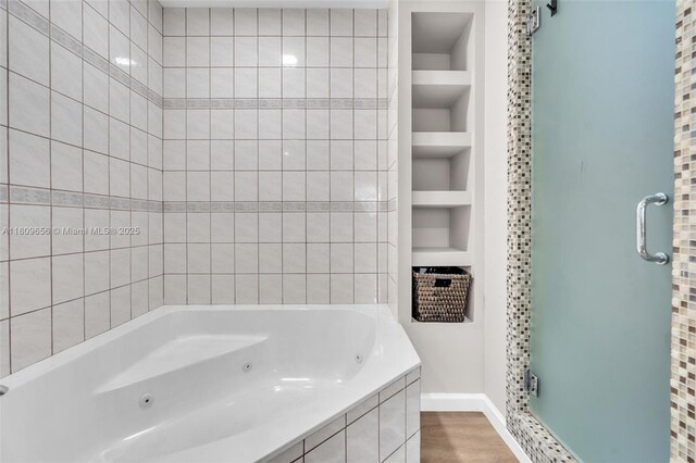 4271 SW 67th Ter, Davie, FL 33314 - bathroom with a shower stall, built in shelves, wood finished floors, baseboards, and a tub with jets