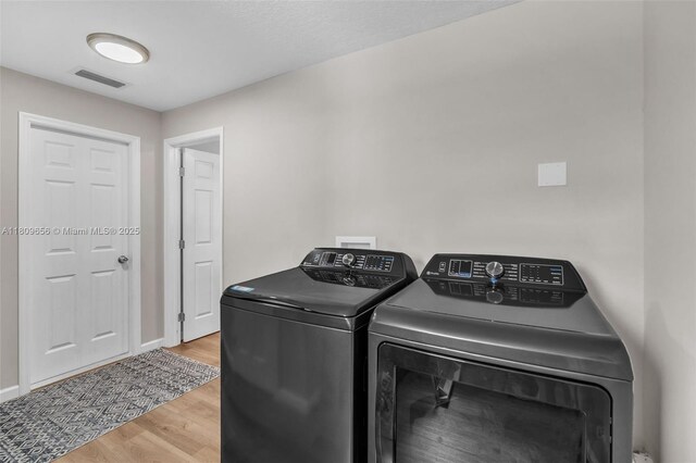 4271 SW 67th Ter, Davie, FL 33314 - laundry area featuring washer and clothes dryer, wood finished floors, and baseboards