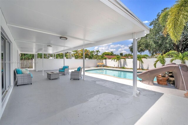 4271 SW 67th Ter, Davie, FL 33314 - view of swimming pool with a water slide, a patio, and a fenced backyard