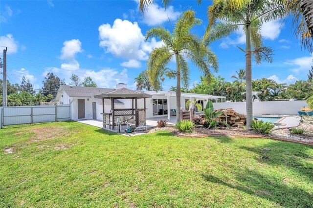 4271 SW 67th Ter, Davie, FL 33314 - back of property with a patio area, stucco siding, and a gazebo
