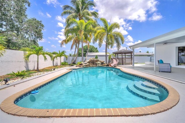 4271 SW 67th Ter, Davie, FL 33314 - view of pool featuring a gazebo, a fenced backyard, a patio area, a ceiling fan, and a water slide