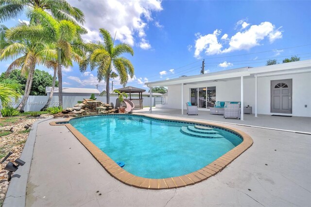 4271 SW 67th Ter, Davie, FL 33314 - view of pool featuring a water slide, a patio area, and an outdoor hangout area