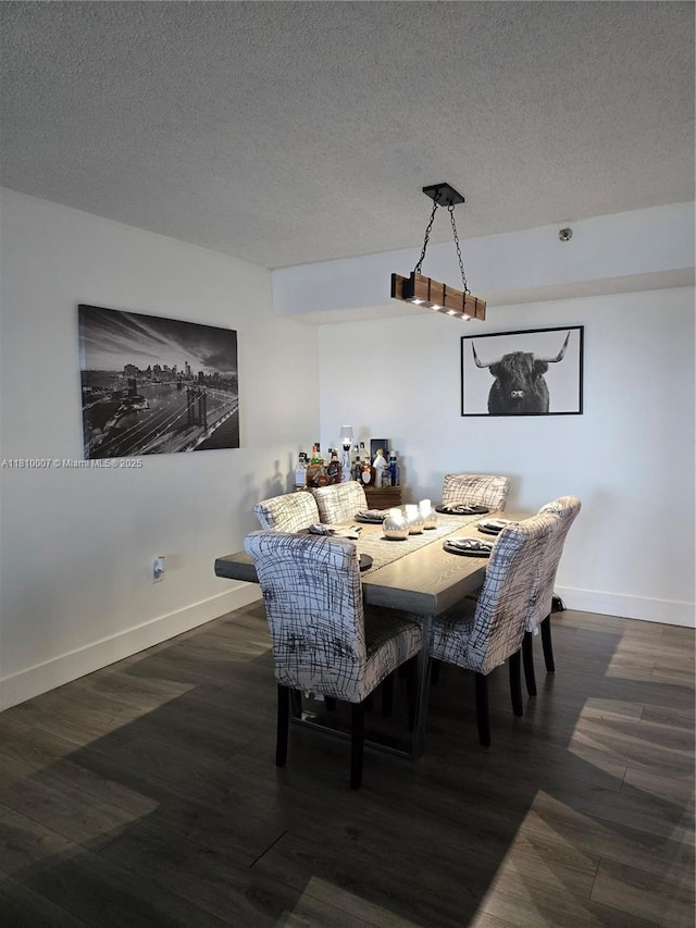 900 NE 195th St Unit 709, Miami, FL 33179 - dining room with wood finished floors, baseboards, and a textured ceiling