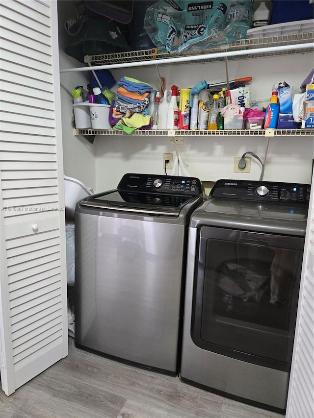 900 NE 195th St Unit 709, Miami, FL 33179 - washroom with washing machine and dryer and wood finished floors