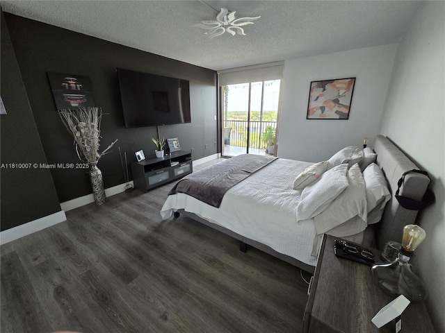 900 NE 195th St Unit 709, Miami, FL 33179 - bedroom featuring access to exterior, wood finished floors, a textured ceiling, and baseboards