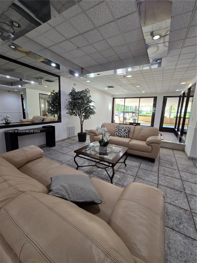 900 NE 195th St Unit 709, Miami, FL 33179 - living room featuring a drop ceiling and healthy amount of natural light
