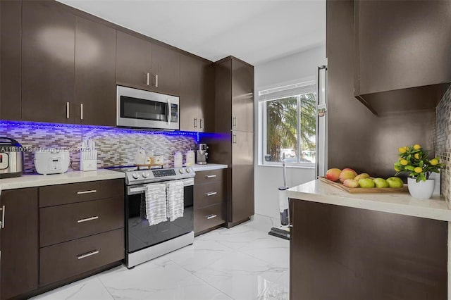 17306 SW 139th Ct, Miami, FL 33177 - kitchen with stainless steel appliances, light marble finish flooring, light countertops, and decorative backsplash