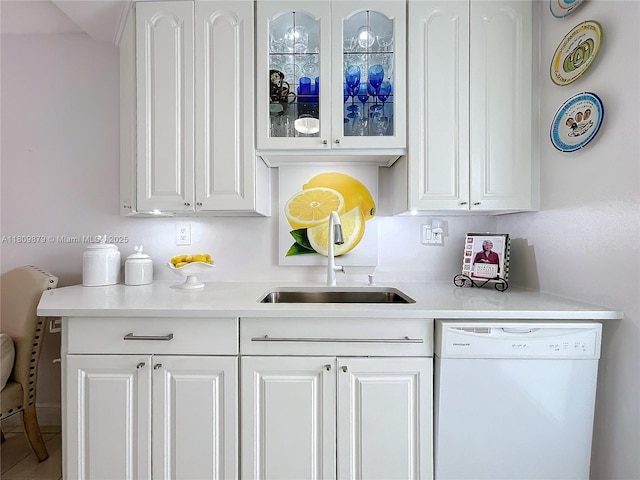 708 SE 7th Ave Unit 14, Pompano Beach, FL 33060 - kitchen with dishwasher, white cabinets, glass insert cabinets, light countertops, and a sink