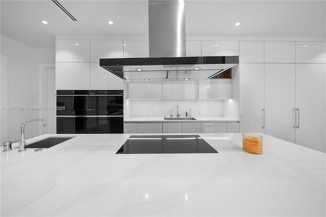 9450 SW 98th St, Miami, FL 33176 - kitchen featuring island range hood, modern cabinets, a sink, black appliances, and recessed lighting