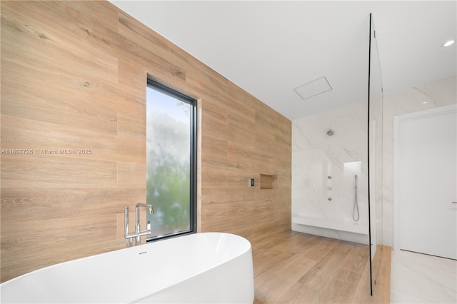 9450 SW 98th St, Miami, FL 33176 - full bath featuring a soaking tub, wood walls, and wood finished floors