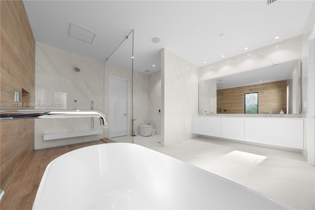 9450 SW 98th St, Miami, FL 33176 - full bath with double vanity, a soaking tub, wood finished floors, and recessed lighting