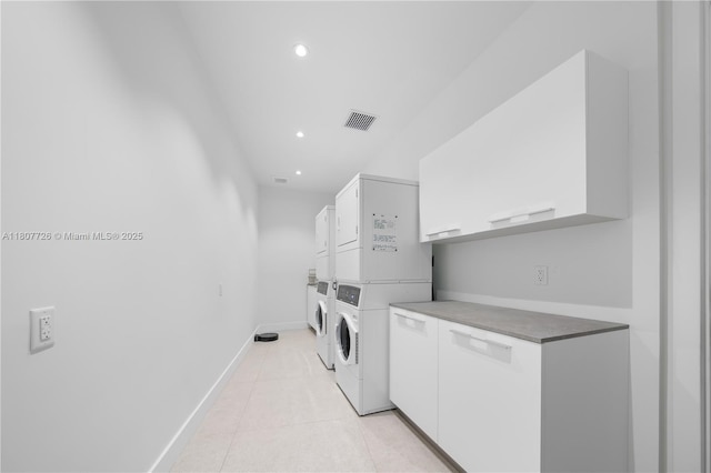 9450 SW 98th St, Miami, FL 33176 - washroom featuring estacked washer and dryer, cabinet space, recessed lighting, baseboards, and light tile patterned floors