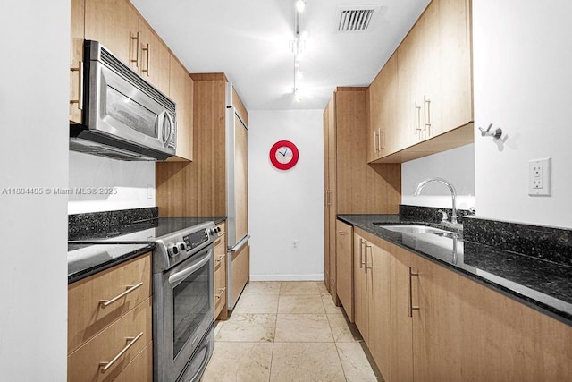 10275 Collins Ave Unit 1506, Bal Harbour, FL 33154 - kitchen with appliances with stainless steel finishes, dark stone countertops, and rail lighting