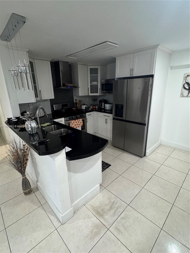 1929 SW 50th Ave, Fort Lauderdale, FL 33317 - kitchen featuring appliances with stainless steel finishes, wall chimney exhaust hood, dark countertops, a peninsula, and glass insert cabinets