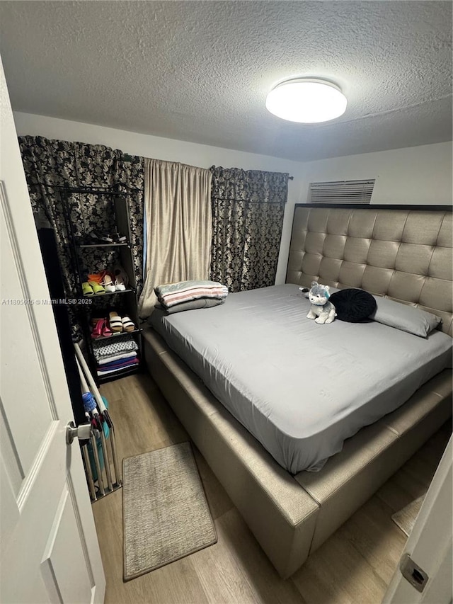 1929 SW 50th Ave, Fort Lauderdale, FL 33317 - bedroom featuring wood finished floors and a textured ceiling