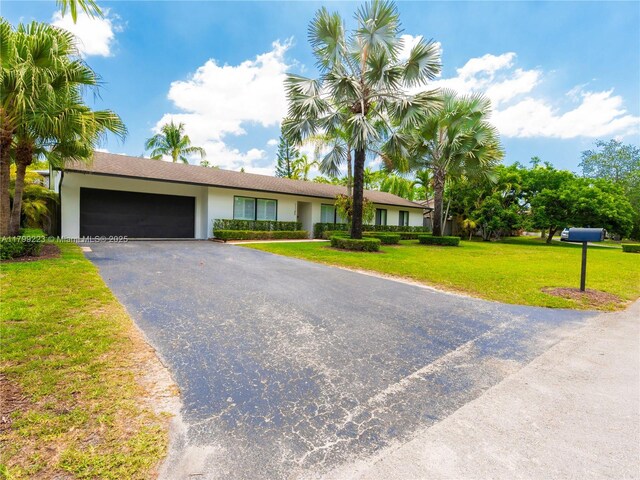 11145 SW 126th St, Miami, FL 33176 - ranch-style house with a garage, stucco siding, driveway, and a front lawn
