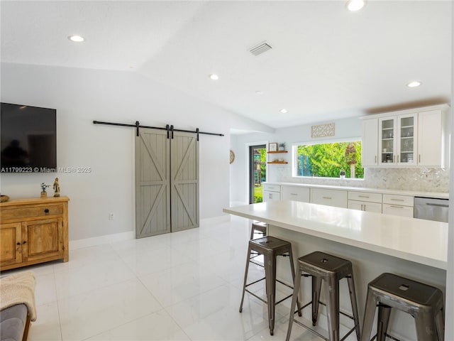 11145 SW 126th St, Miami, FL 33176 - kitchen featuring a barn door, a breakfast bar area, light countertops, vaulted ceiling, and recessed lighting