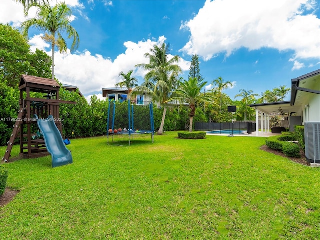 11145 SW 126th St, Miami, FL 33176 - view of yard with central AC unit, a playground, ceiling fan, a patio area, and a trampoline