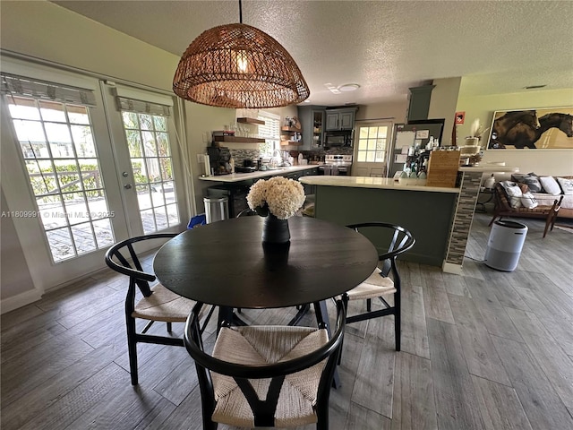 1230 F Rd, Loxahatchee, FL 33470 - dining area featuring a textured ceiling, light wood finished floors, and french doors