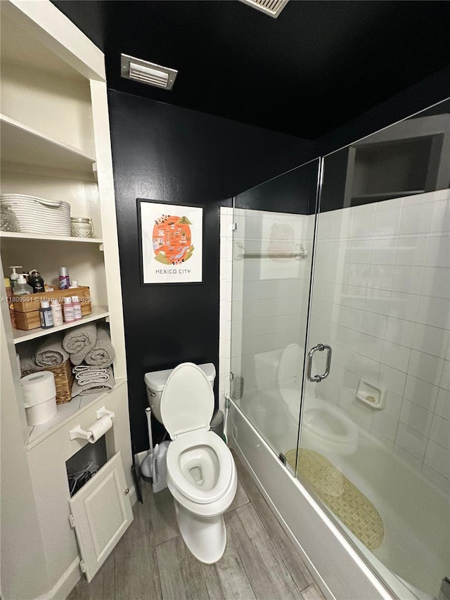 1230 F Rd, Loxahatchee, FL 33470 - bathroom featuring wood finished floors and combined bath / shower with glass door