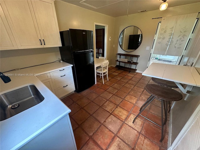 1230 F Rd, Loxahatchee, FL 33470 - kitchen featuring freestanding refrigerator, light countertops, a sink, and baseboards
