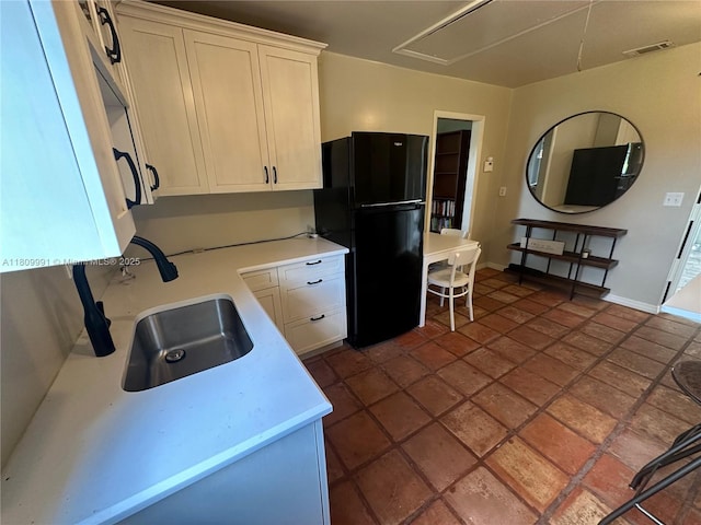 1230 F Rd, Loxahatchee, FL 33470 - kitchen featuring freestanding refrigerator, light countertops, and white cabinetry