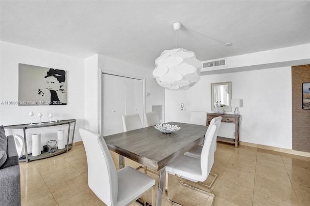 9195 Collins Ave Unit 304, Surfside, FL 33154 - dining space featuring light tile patterned flooring, baseboards, and a chandelier