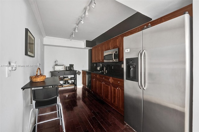 9195 Collins Ave Unit 304, Surfside, FL 33154 - kitchen featuring stainless steel appliances, dark countertops, dark wood finished floors, a sink, and track lighting