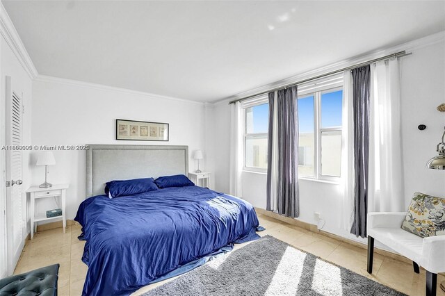 9195 Collins Ave Unit 304, Surfside, FL 33154 - bedroom featuring ornamental molding, light tile patterned floors, and baseboards