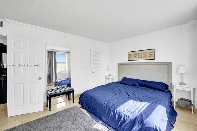 9195 Collins Ave Unit 304, Surfside, FL 33154 - bedroom with ornamental molding, light tile patterned floors, and baseboards