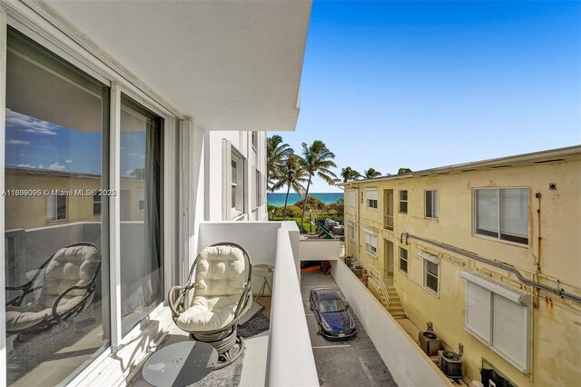 9195 Collins Ave Unit 304, Surfside, FL 33154 - hallway featuring a tray ceiling and baseboards