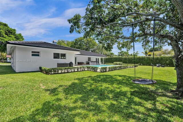 7941 SW 143rd St, Palmetto Bay, FL 33158 - back of house with stucco siding and a yard