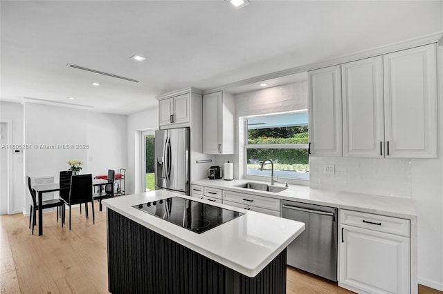 7941 SW 143rd St, Palmetto Bay, FL 33158 - kitchen featuring stainless steel appliances, a sink, healthy amount of natural light, white cabinets, and recessed lighting