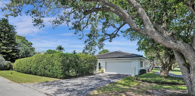7941 SW 143rd St, Palmetto Bay, FL 33158 - view of front of home featuring a garage, stucco siding, and a front lawn