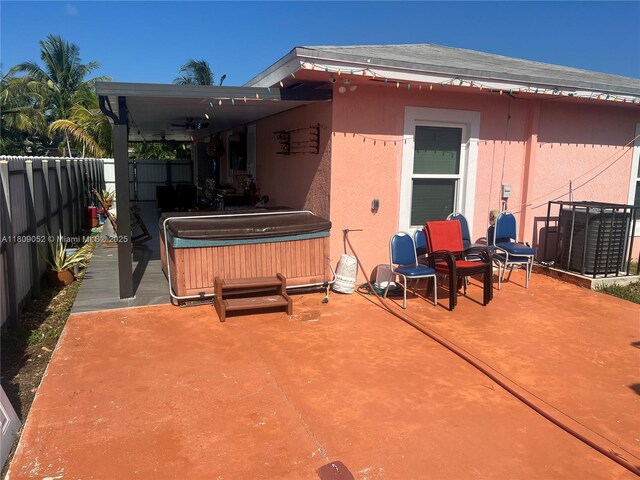 20390 SW 119th Ave, Miami, FL 33177 - back of property with a hot tub, a patio area, and a fenced backyard