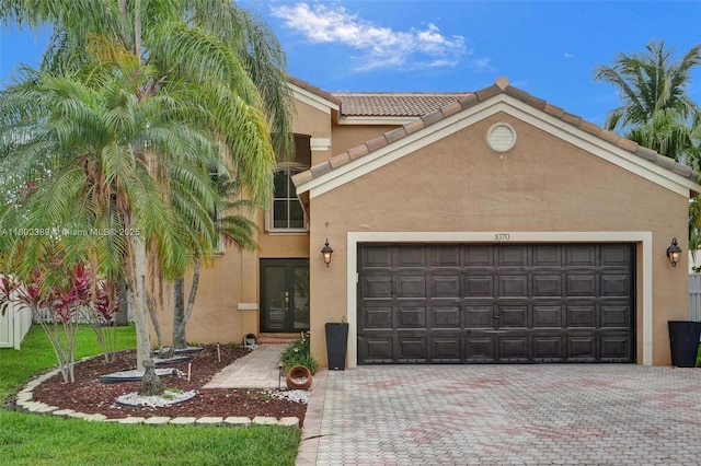 1070 Briar Ridge Rd, Weston, FL 33327 - view of front facade with a garage, decorative driveway, and stucco siding