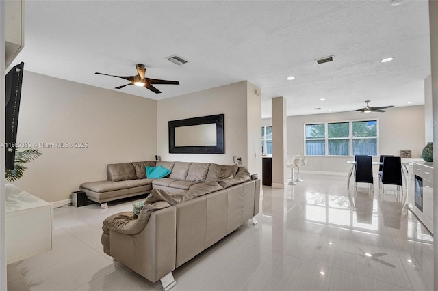 1070 Briar Ridge Rd, Weston, FL 33327 - living area with ceiling fan, light tile patterned floors, and baseboards