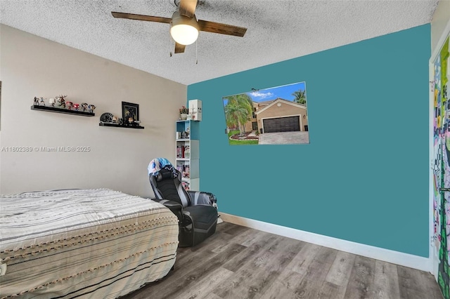 1070 Briar Ridge Rd, Weston, FL 33327 - bedroom featuring a textured ceiling, wood finished floors, a ceiling fan, and baseboards