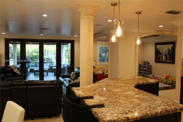 9941 SW 97th Ct, Miami, FL 33176 - kitchen with arched walkways, open floor plan, decorative columns, light stone countertops, and recessed lighting