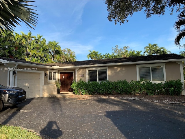 9941 SW 97th Ct, Miami, FL 33176 - single story home with stucco siding, a garage, and asphalt driveway