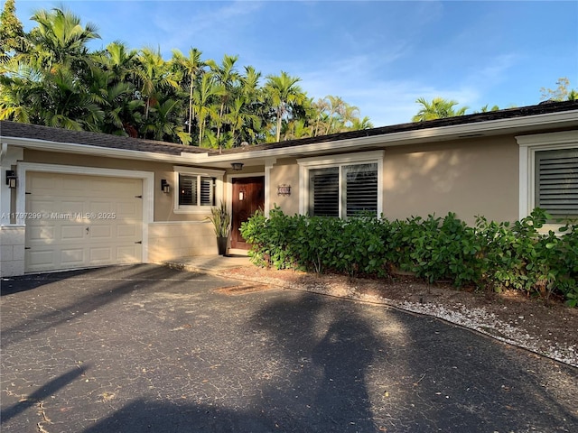 9941 SW 97th Ct, Miami, FL 33176 - single story home featuring an attached garage, stucco siding, and asphalt driveway
