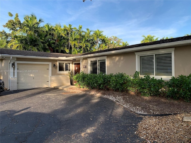 9941 SW 97th Ct, Miami, FL 33176 - ranch-style house featuring a garage, stucco siding, and driveway