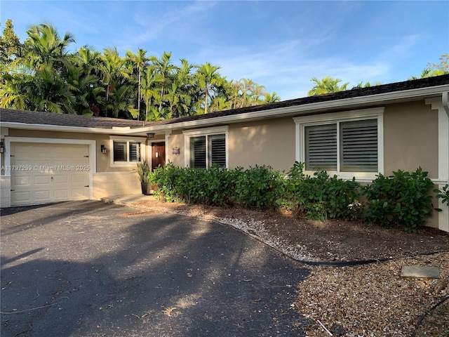 9941 SW 97th Ct, Miami, FL 33176 - single story home featuring a garage, stucco siding, and asphalt driveway
