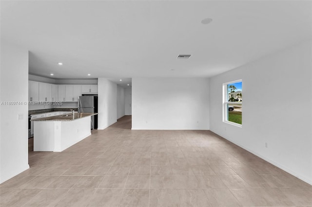 1130 SW Jericho Ave, Port St Lucie, FL 34953 - unfurnished living room featuring recessed lighting and a sink