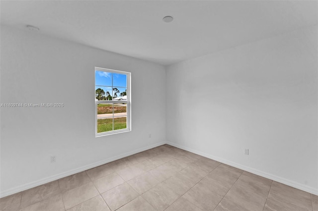 1130 SW Jericho Ave, Port St Lucie, FL 34953 - spare room with baseboards and light tile patterned flooring