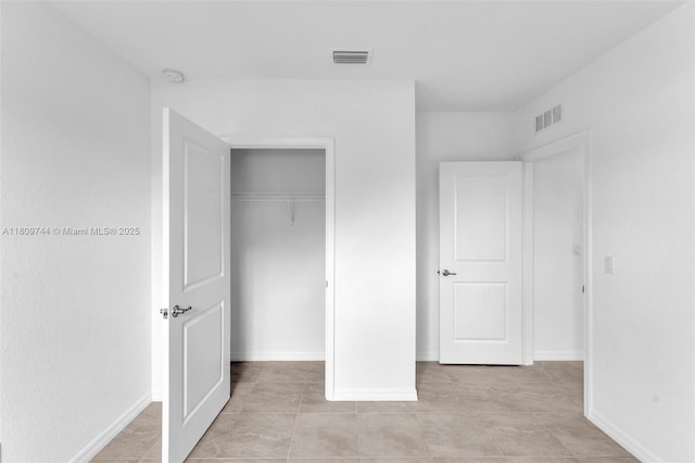 1130 SW Jericho Ave, Port St Lucie, FL 34953 - unfurnished bedroom with a closet and light tile patterned flooring