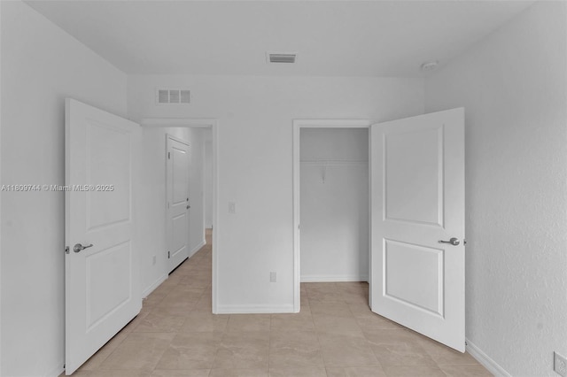 1130 SW Jericho Ave, Port St Lucie, FL 34953 - unfurnished bedroom with a closet and light tile patterned flooring