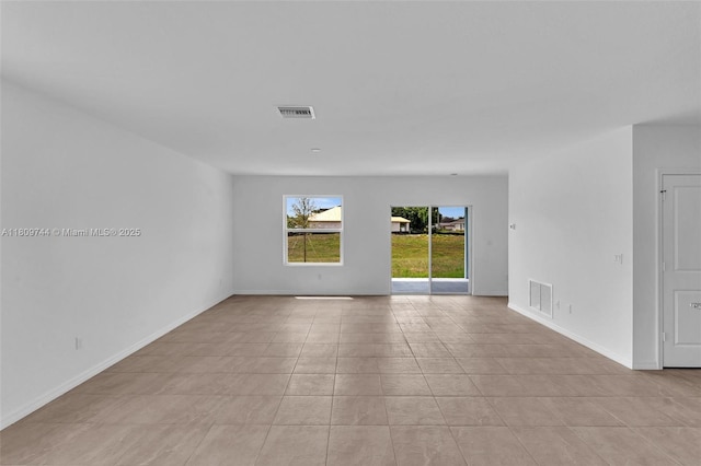 1130 SW Jericho Ave, Port St Lucie, FL 34953 - empty room with light tile patterned floors and baseboards