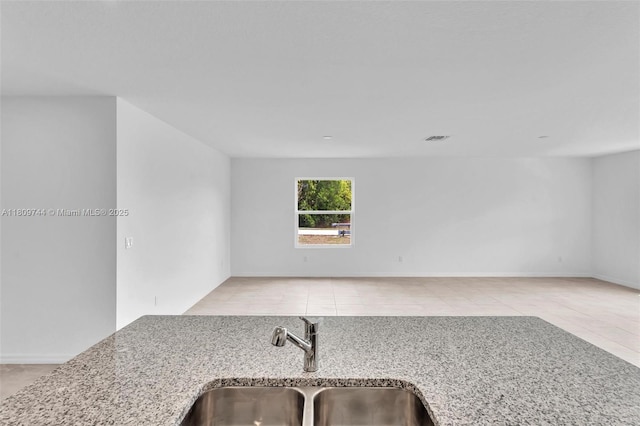 1130 SW Jericho Ave, Port St Lucie, FL 34953 - kitchen featuring light stone countertops and tile patterned flooring